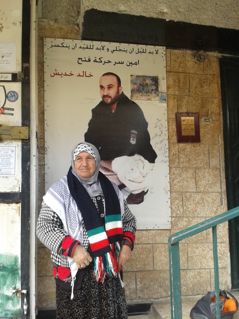 A woman in  in Balata, beside the picture of her imprisoned son. Photo by Leigh Hoffman.